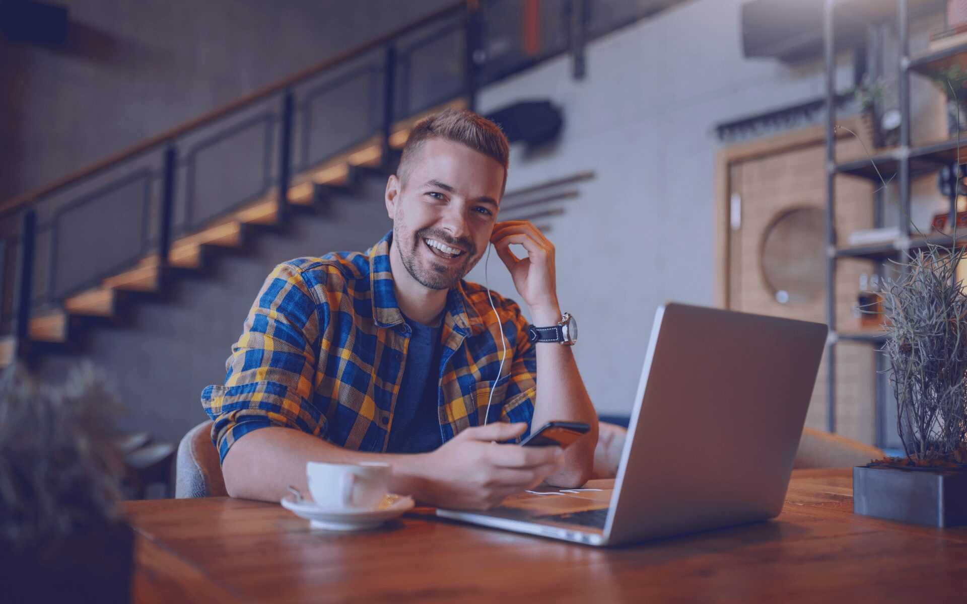 man smiling at his laptop