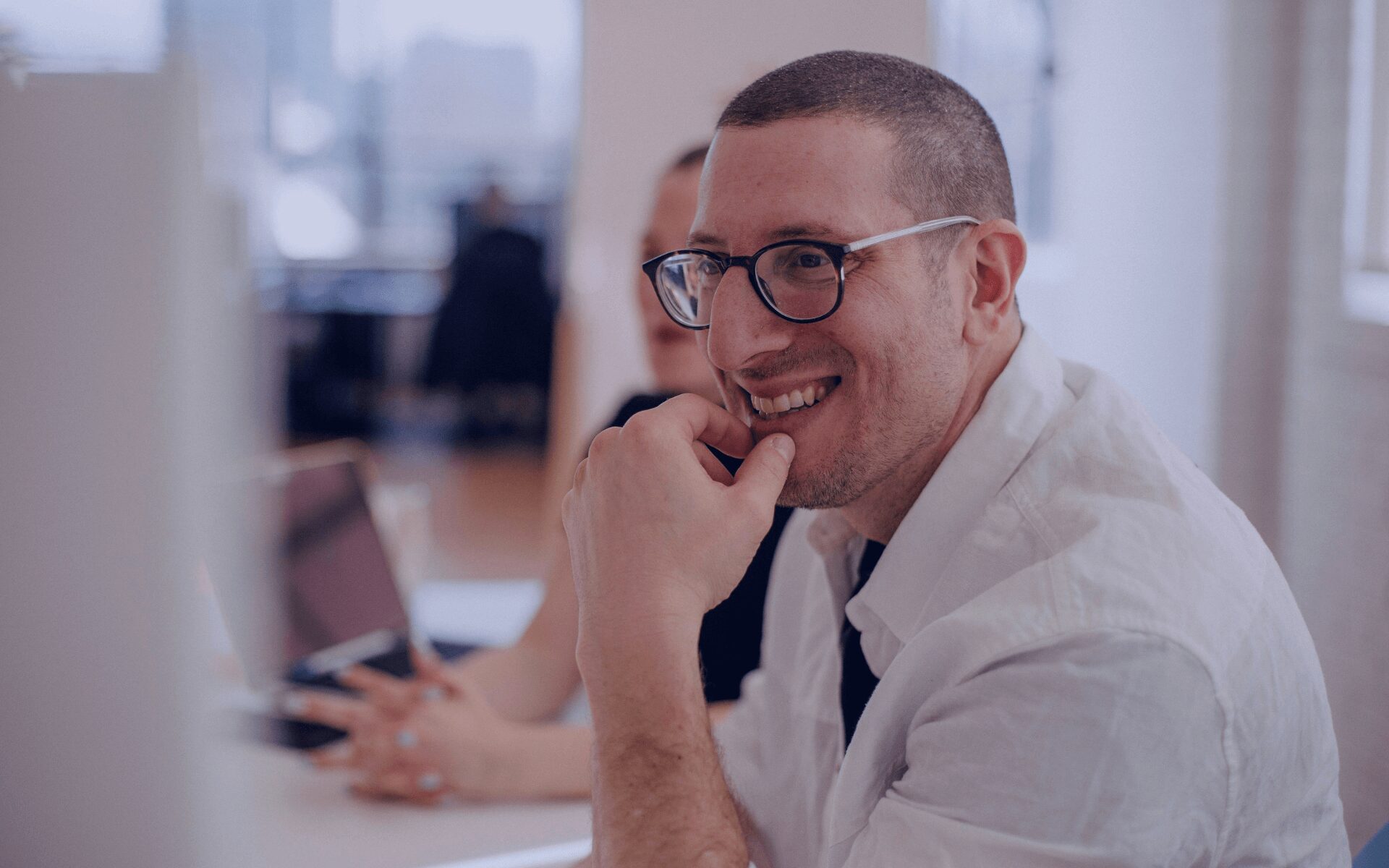 man smiling in a meeting