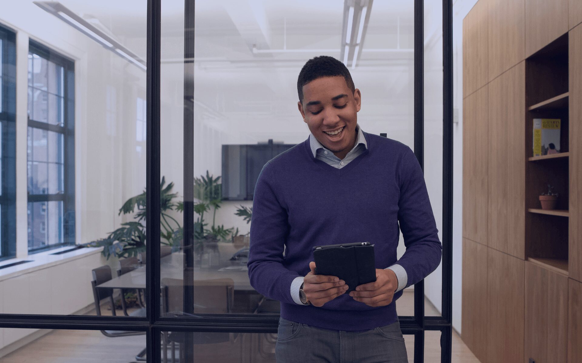 man smiling on his tablet