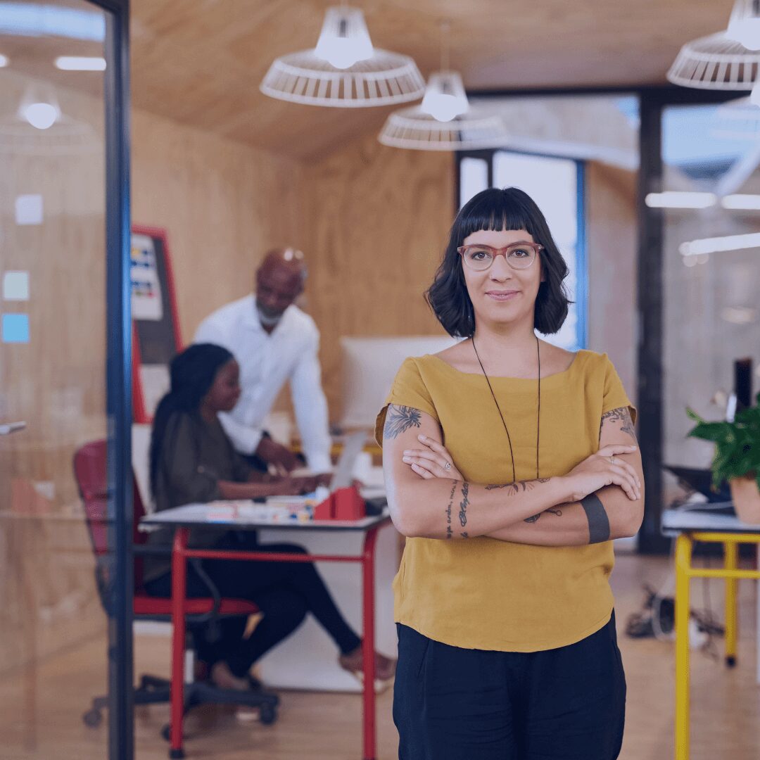 woman with tattoos and glasses smiling
